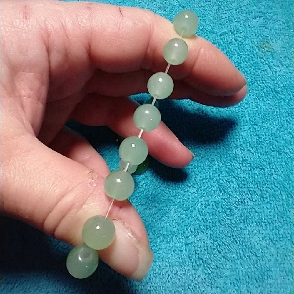 Goldtone green faux jade wheel stretch bracelet